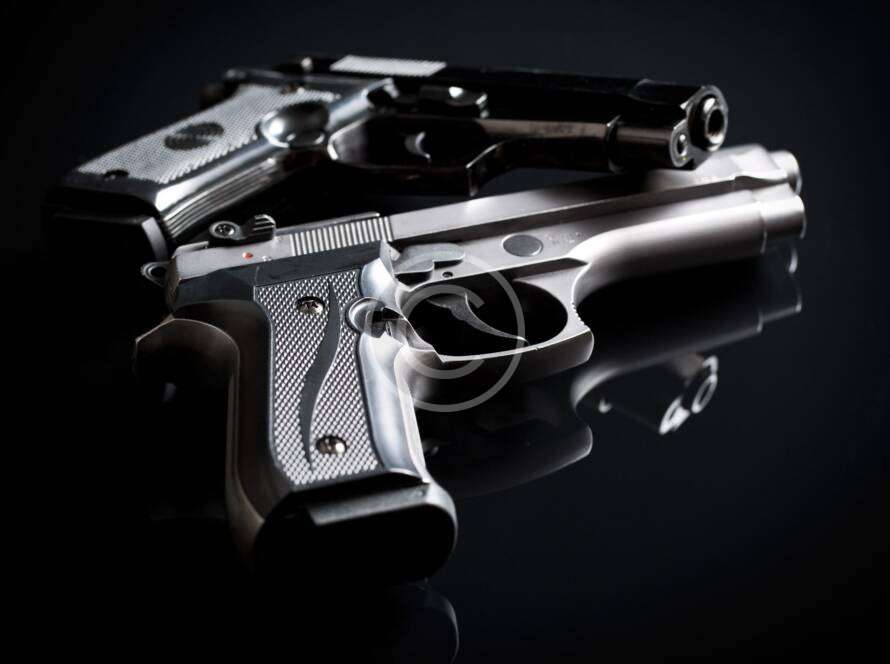 A beginner handling a handgun at a shooting range.