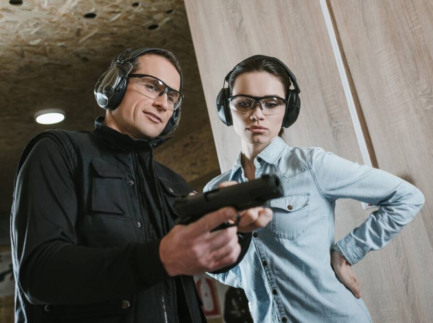 A beginner practicing safe handgun operation at a shooting range.