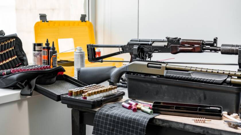 A firearm being cleaned with essential gun maintenance tools.
